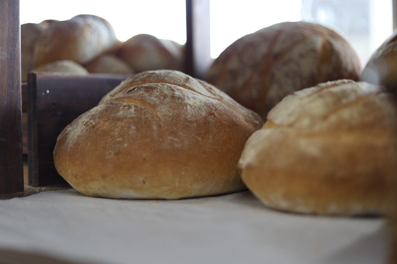 Round artisanal loaves cooling on the EuroDeli bakery counter